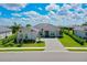Stunning single-story home with a gray roof, manicured lawn, and a paved driveway at 17336 Sandpearl Rd, Venice, FL 34293