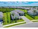 Beautiful home featuring a stone driveway, lush lawn and mature landscaping at 17336 Sandpearl Rd, Venice, FL 34293