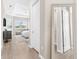 Hallway view leading into bedroom with tile floors, tray ceilings, and closet access at 17336 Sandpearl Rd, Venice, FL 34293