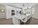 Modern kitchen featuring white cabinets, a center island with seating, and stainless steel appliances at 17336 Sandpearl Rd, Venice, FL 34293