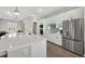 Kitchen features stainless steel appliances, stylish backsplash, and white cabinets with long island and open floor plan at 17336 Sandpearl Rd, Venice, FL 34293
