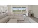 Comfortable living room features a large window and a plush sectional sofa at 17336 Sandpearl Rd, Venice, FL 34293