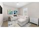 Relax in this comfortable living area featuring a sectional sofa and lots of natural light at 17336 Sandpearl Rd, Venice, FL 34293