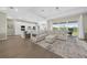 Open-concept living space featuring modern decor, tile flooring, and sliding glass doors to the backyard at 17336 Sandpearl Rd, Venice, FL 34293