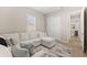 Bright living area showcasing a sectional sofa, neutral walls, and a light accent rug at 17336 Sandpearl Rd, Venice, FL 34293