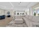 Spacious living room with a large sectional sofa and open floor plan to the kitchen at 17336 Sandpearl Rd, Venice, FL 34293