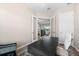 An office space with modern desk and chair offering a view of the living spaces beyond at 17336 Sandpearl Rd, Venice, FL 34293