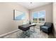 Office space with modern desk, chair, and window, plus a decorative accent chair at 17336 Sandpearl Rd, Venice, FL 34293