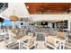 The pool bar offers a relaxing atmosphere with wood ceilings, fans, tvs, and multiple tables and chairs under the shade at 17336 Sandpearl Rd, Venice, FL 34293