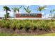 Wellen Park Golf & Country Club sign surrounded by lush landscaping, trees, and blue skies at 17336 Sandpearl Rd, Venice, FL 34293