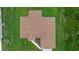 Aerial view of the home's roof and landscaping showing the architectural design and well-kept yard at 1983 Longstroth Ave, North Port, FL 34288