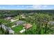 Aerial view of a single-Gathering home surrounded by lush greenery and tall trees in a peaceful neighborhood at 1983 Longstroth Ave, North Port, FL 34288