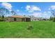 Sprawling backyard with well-maintained lawn, views of neighboring houses, and a peek at the patio at 1983 Longstroth Ave, North Port, FL 34288
