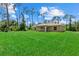 A lush green backyard offers ample space for recreation and relaxation, complemented by a well-maintained lawn at 1983 Longstroth Ave, North Port, FL 34288