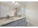 Bathroom featuring granite countertop, double sinks, and a shower in the background at 1983 Longstroth Ave, North Port, FL 34288