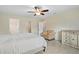 Serene bedroom features tile flooring, ceiling fan, walk-in closet, and natural light at 1983 Longstroth Ave, North Port, FL 34288