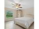 Bright bedroom featuring a large window and tiled flooring overlooking the lawn at 1983 Longstroth Ave, North Port, FL 34288