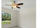 Bedroom with tile floors, a ceiling fan, and a window offering views of the lush greenery outside at 1983 Longstroth Ave, North Port, FL 34288