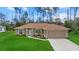Charming single-story home with manicured lawn, two car garage and beautiful landscaping at 1983 Longstroth Ave, North Port, FL 34288