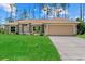 Inviting single-story home featuring a well-kept lawn and a two-car garage at 1983 Longstroth Ave, North Port, FL 34288
