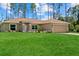 Charming single-story home with manicured lawn, attractive landscaping, and two car garage at 1983 Longstroth Ave, North Port, FL 34288