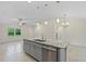 Open concept kitchen featuring an island with granite countertop and stainless steel appliances at 1983 Longstroth Ave, North Port, FL 34288