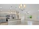 Open-concept kitchen with stainless steel appliances and an island with granite countertops at 1983 Longstroth Ave, North Port, FL 34288