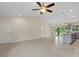 Open living space with light tile flooring, ceiling fan, and kitchen island at 1983 Longstroth Ave, North Port, FL 34288