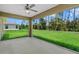 This screened patio has a ceiling fan and stunning views of the lush green backyard at 1983 Longstroth Ave, North Port, FL 34288