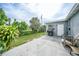 Backyard features a patio area, lush greenery, and a privacy fence at 21524 Edgewater Dr, Port Charlotte, FL 33952