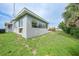 Spacious backyard with lush greenery and the exterior of the Florida room at 21524 Edgewater Dr, Port Charlotte, FL 33952