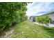 Backyard with lush greenery and the exterior of the home at 21524 Edgewater Dr, Port Charlotte, FL 33952