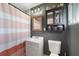 Bathroom with white vanity, medicine cabinet, and a shower with a striped curtain at 21524 Edgewater Dr, Port Charlotte, FL 33952