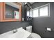 Bathroom with white vanity, dark walls, and a large mirror at 21524 Edgewater Dr, Port Charlotte, FL 33952