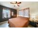 Bedroom featuring a king-sized bed, wood shelving, neutral colors, and a ceiling fan at 21524 Edgewater Dr, Port Charlotte, FL 33952