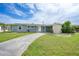 Charming single-story home featuring a well-manicured lawn and a long driveway at 21524 Edgewater Dr, Port Charlotte, FL 33952