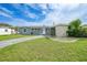 Charming single-story home with a well-manicured lawn and a long driveway under a sunny blue sky at 21524 Edgewater Dr, Port Charlotte, FL 33952