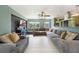 Inviting living room featuring tile flooring, ample seating, and a large television at 21524 Edgewater Dr, Port Charlotte, FL 33952