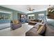 Bright living room with tile floors, a ceiling fan, comfortable seating, and sliding glass door access to the porch at 21524 Edgewater Dr, Port Charlotte, FL 33952