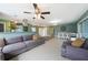 Open living and dining area with tile flooring, a modern ceiling fan, bench seating, and access to the kitchen at 21524 Edgewater Dr, Port Charlotte, FL 33952