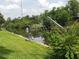 Canal view featuring a boat dock and lift with a well-maintained grassy shoreline at 2220 Broad Ranch Dr, Port Charlotte, FL 33948