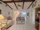 Living room featuring vaulted ceiling with exposed wood beams and tiled floors at 2220 Broad Ranch Dr, Port Charlotte, FL 33948