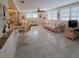Bright living room featuring tile floors, plantation shutters, and comfortable seating at 2220 Broad Ranch Dr, Port Charlotte, FL 33948
