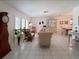 Spacious living room features tiled floors, bright windows, and comfortable seating at 2220 Broad Ranch Dr, Port Charlotte, FL 33948