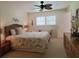 Comfortable main bedroom featuring neutral walls, wood furnishings, and coastal decor at 2220 Broad Ranch Dr, Port Charlotte, FL 33948