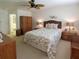 Comfortable main bedroom with tropical bedding, ceiling fan, and ensuite bathroom at 2220 Broad Ranch Dr, Port Charlotte, FL 33948