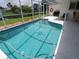 Screened in pool with blue tile, a star design, and steps leading into the water at 2220 Broad Ranch Dr, Port Charlotte, FL 33948
