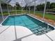 Screened-in pool with canal views, perfect for outdoor relaxation and enjoyment at 2220 Broad Ranch Dr, Port Charlotte, FL 33948