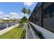 Beautiful backyard canal view with landscaped greenery, black rock, and walkway at 245 Lido Dr, Punta Gorda, FL 33950