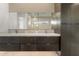 Modern bathroom features a double vanity with sleek gray cabinets, and decorative tiling above at 245 Lido Dr, Punta Gorda, FL 33950